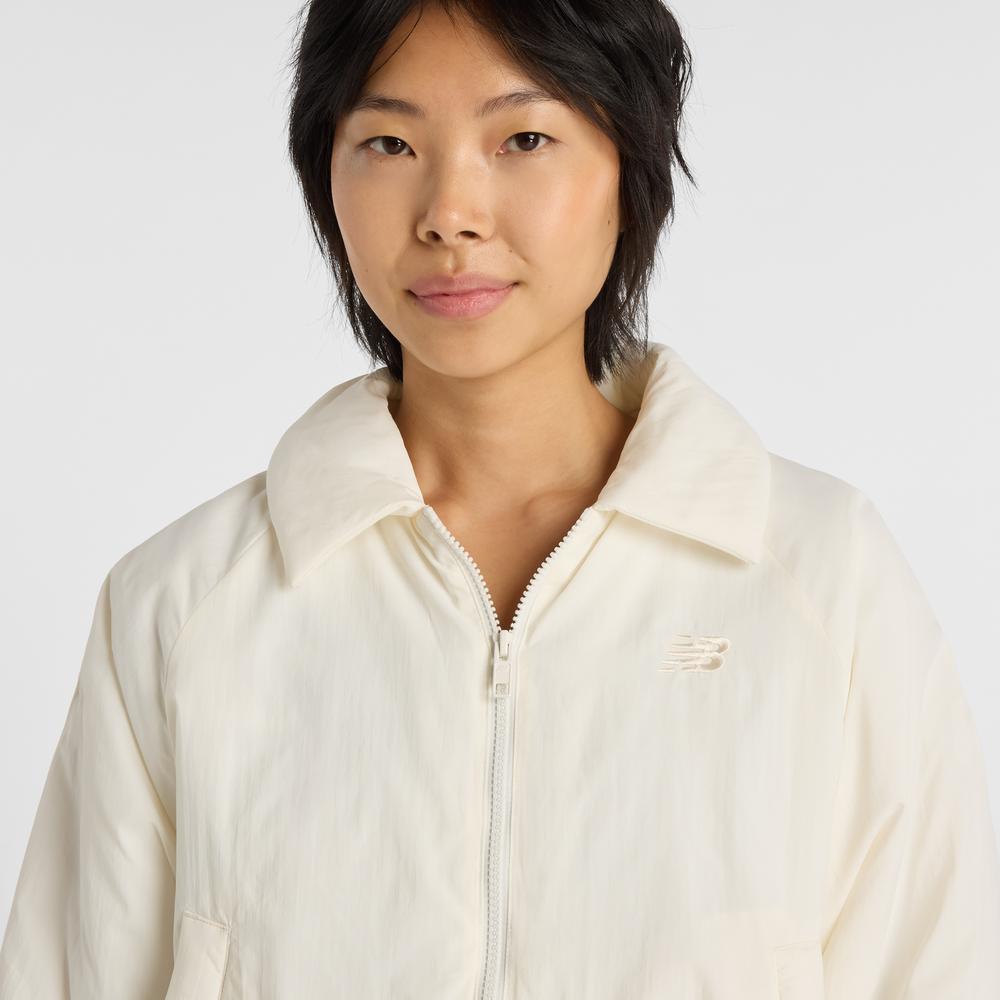 Dámská bunda New Balance WJ61D8YXSST - béžové