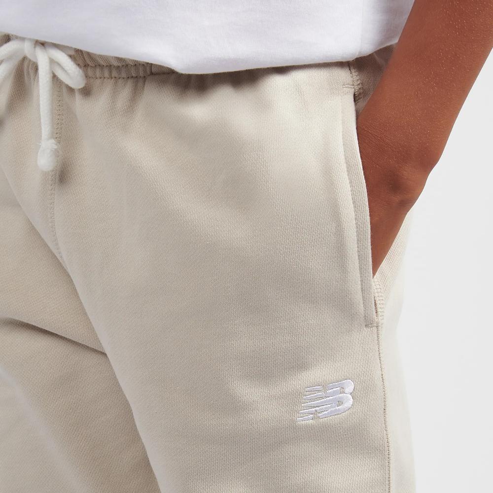 Dětské kalhoty New Balance LAKB0060TWF - béžové